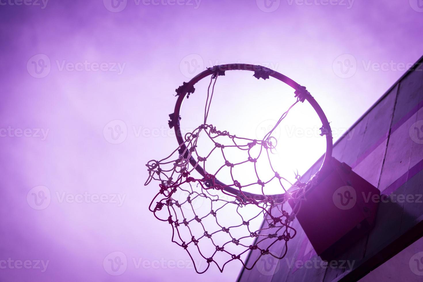 Wooden basketball hoop during sunset. photo