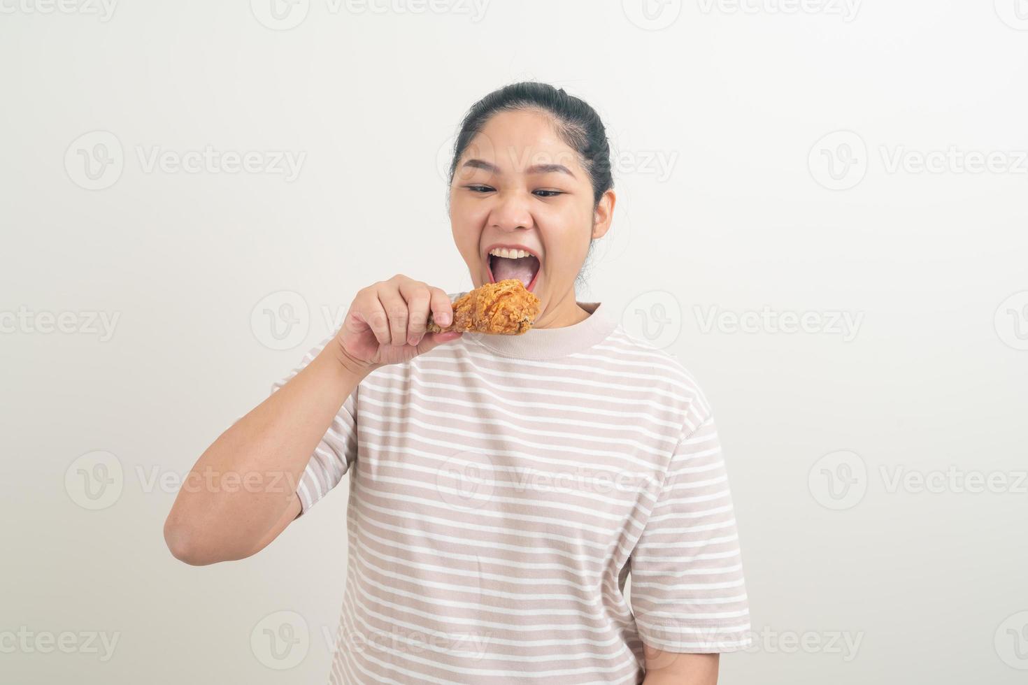 Asian woman with fried chicken on hand photo