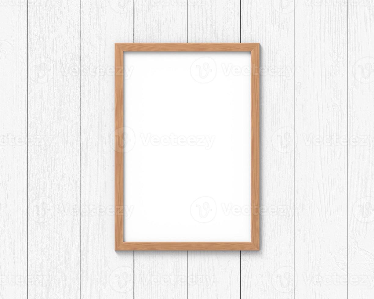 Vertical wooden frames mockup with a border hanging on the wall. Empty base for picture or text. 3D rendering. photo