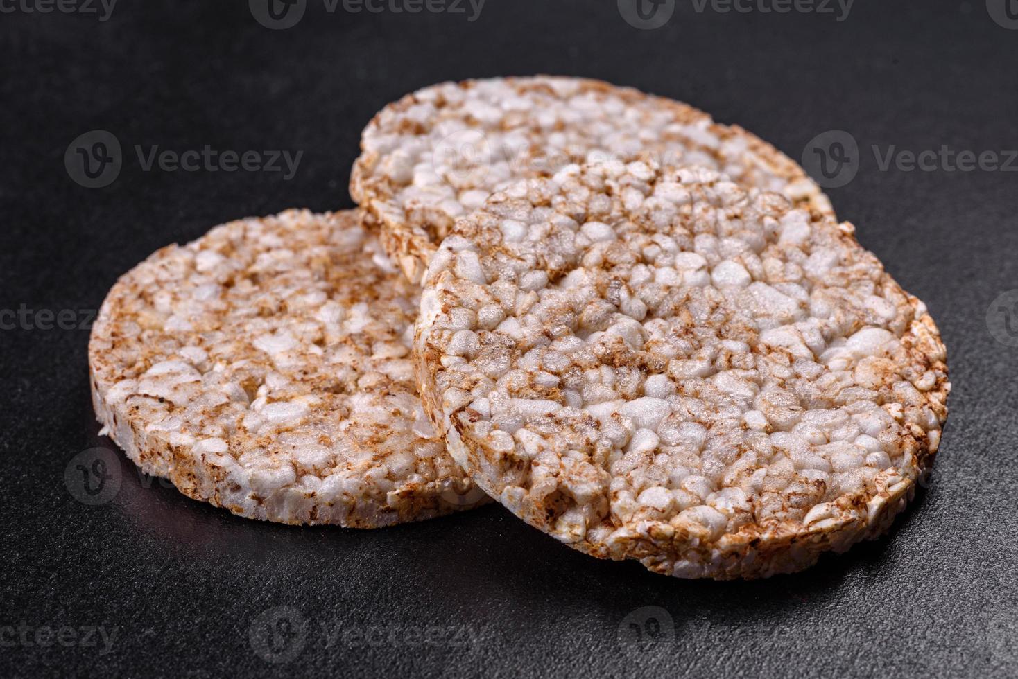 Three round crunchy buckwheat crispbread on a dark concrete background photo