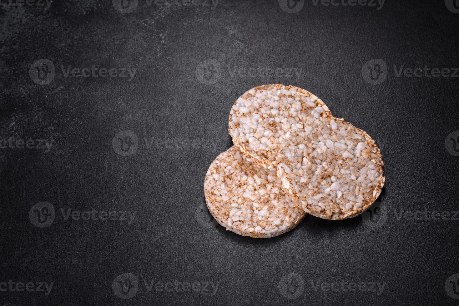 Three round crunchy buckwheat crispbread on a dark concrete background photo