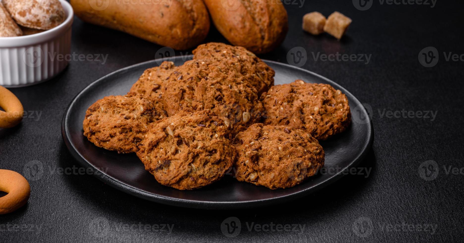 Tasty fresh oat cookies on a dark concrete background photo
