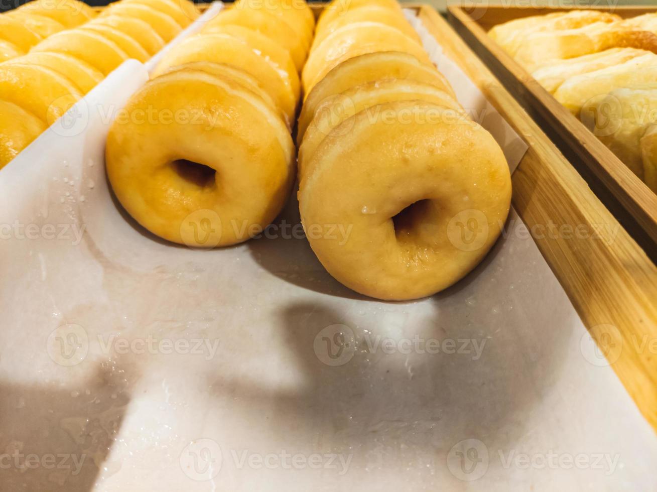 Closeup of tasty donuts in old wooden boxes photo