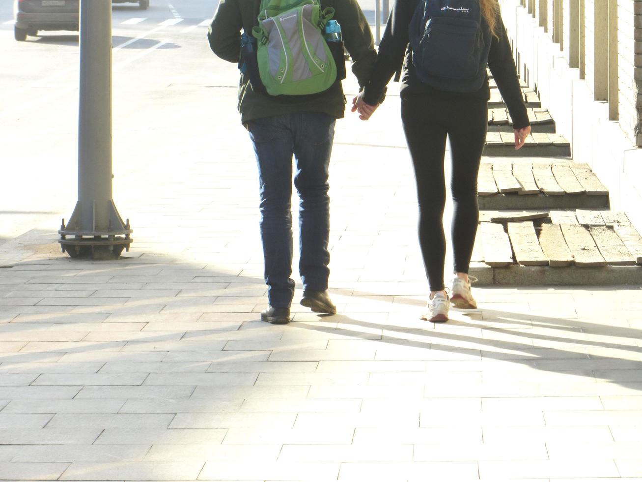 Moscow, Russia. April 14, 2018. Young couple walks holding hands photo