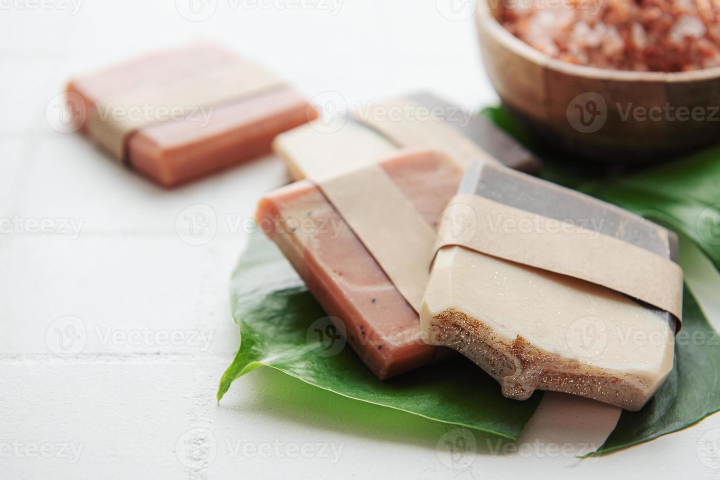 Handmade soap bars and green leaves photo