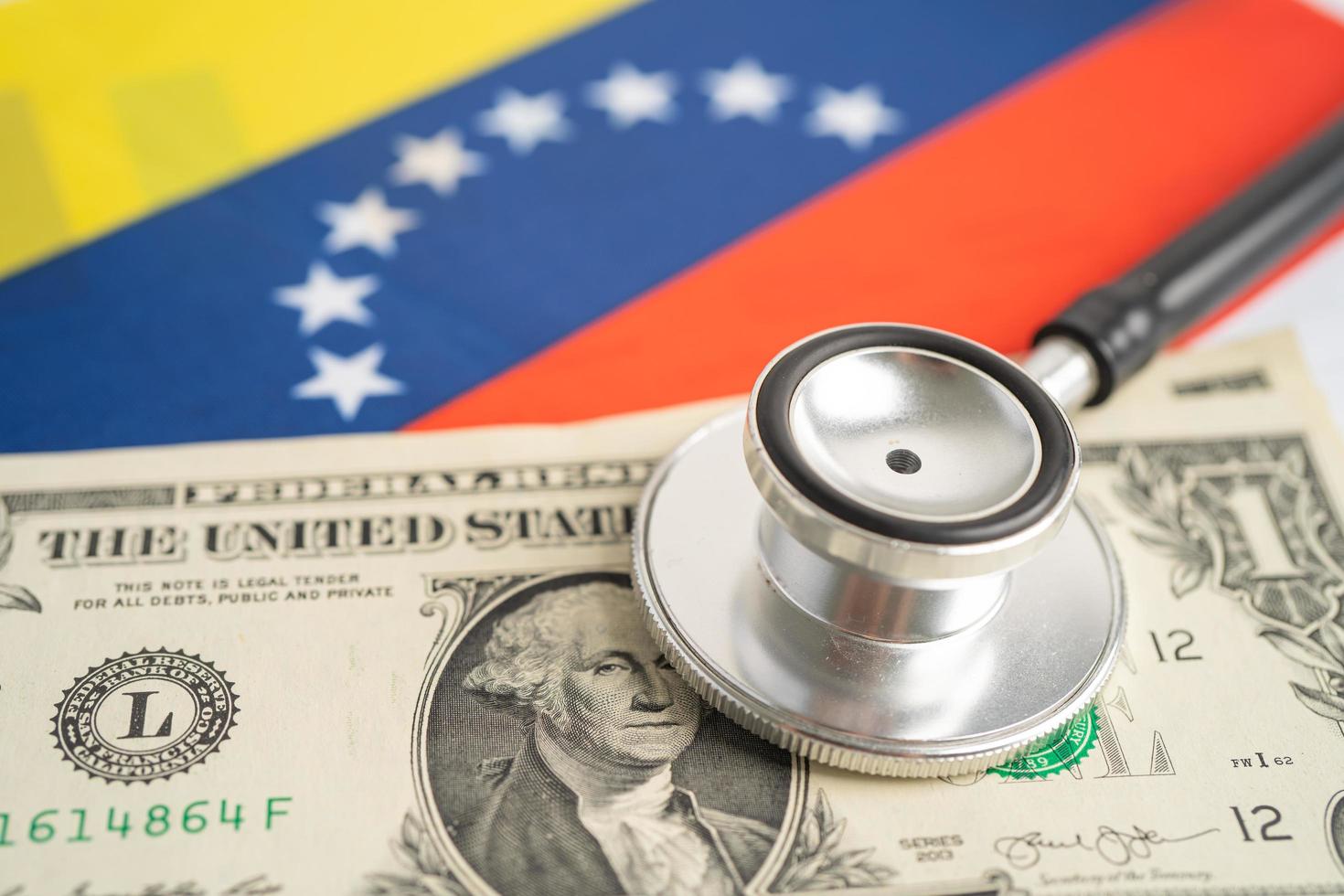 Black stethoscope with US dollar banknotes on Venezuela flag background, Business and finance concept. photo