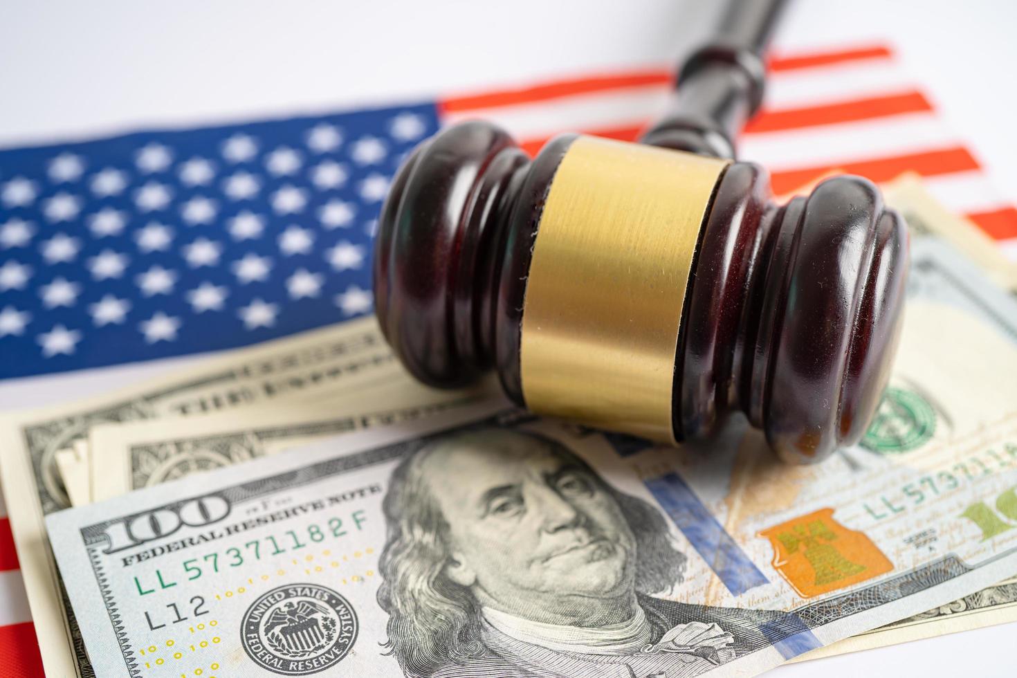 Gavel for judge lawyer and US dollar banknotes on USA America flag, finance concept. photo