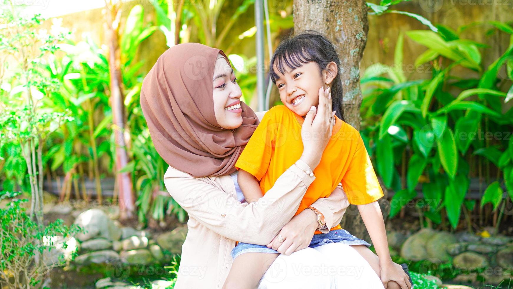 mother and daughter play and have fun in the park photo