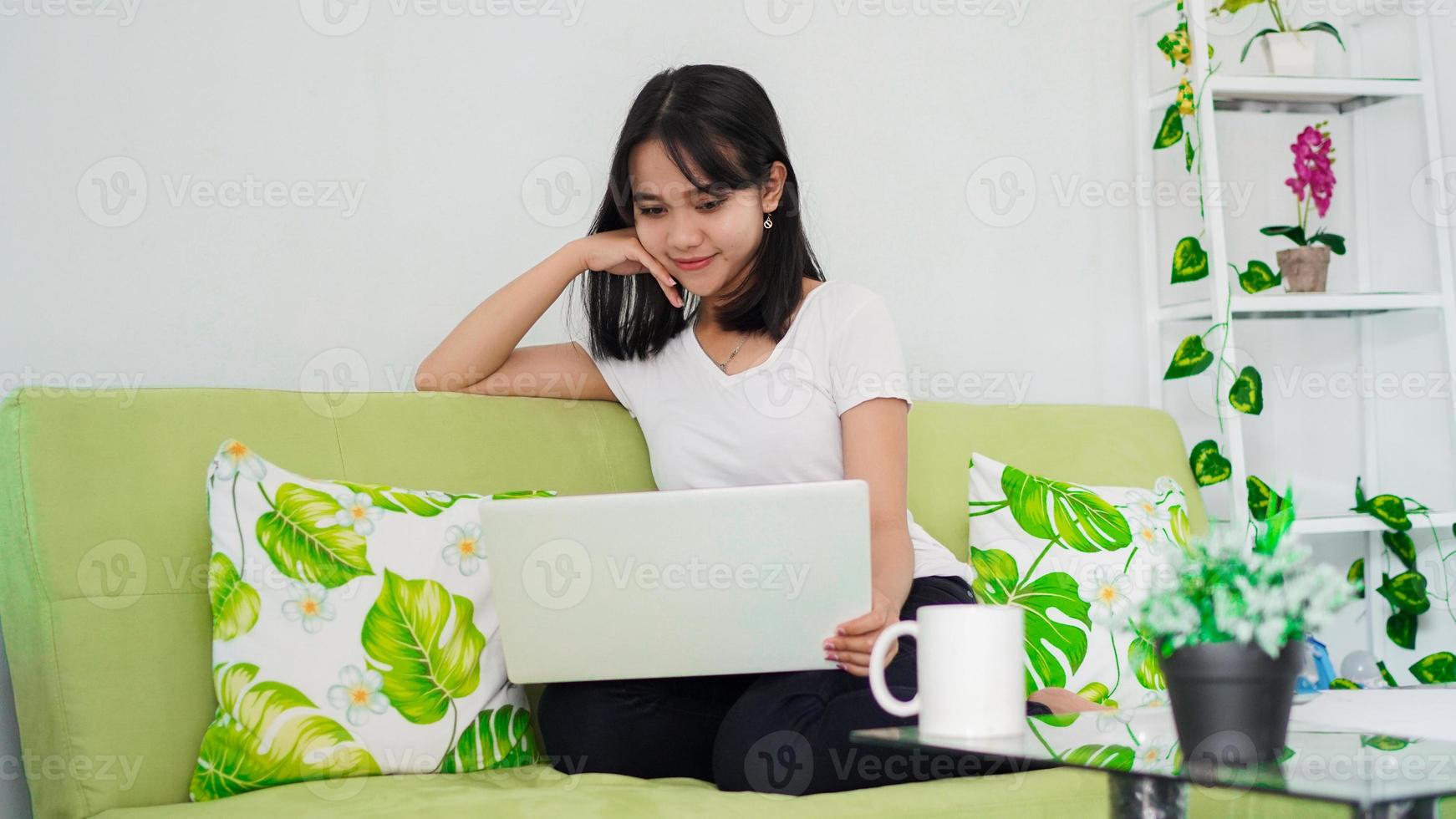 asian women sitting on chair work from home at laptop and thinking of problem solution photo