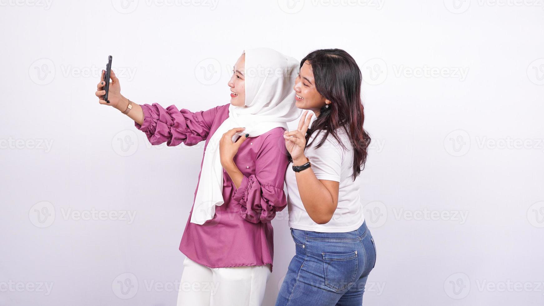 two asian women doing selfies isolated white background photo