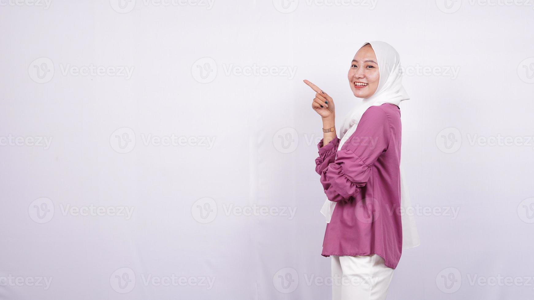 beautiful women hijab pointing blank area on left isolated white background photo