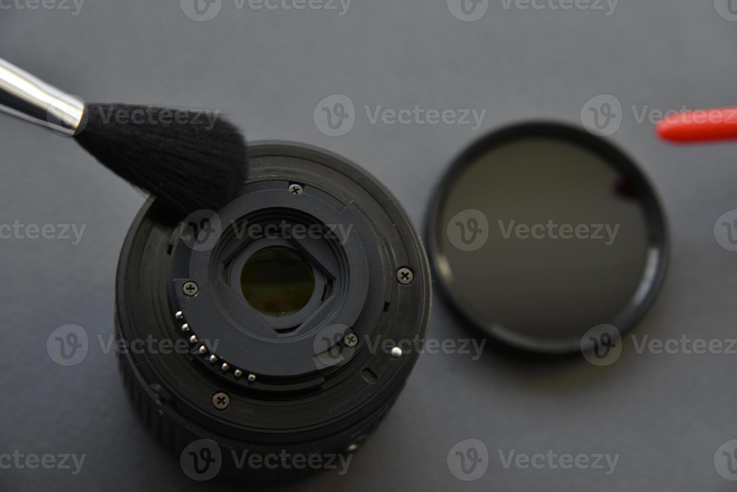 Cleaning photo lenses with a brush and a pear