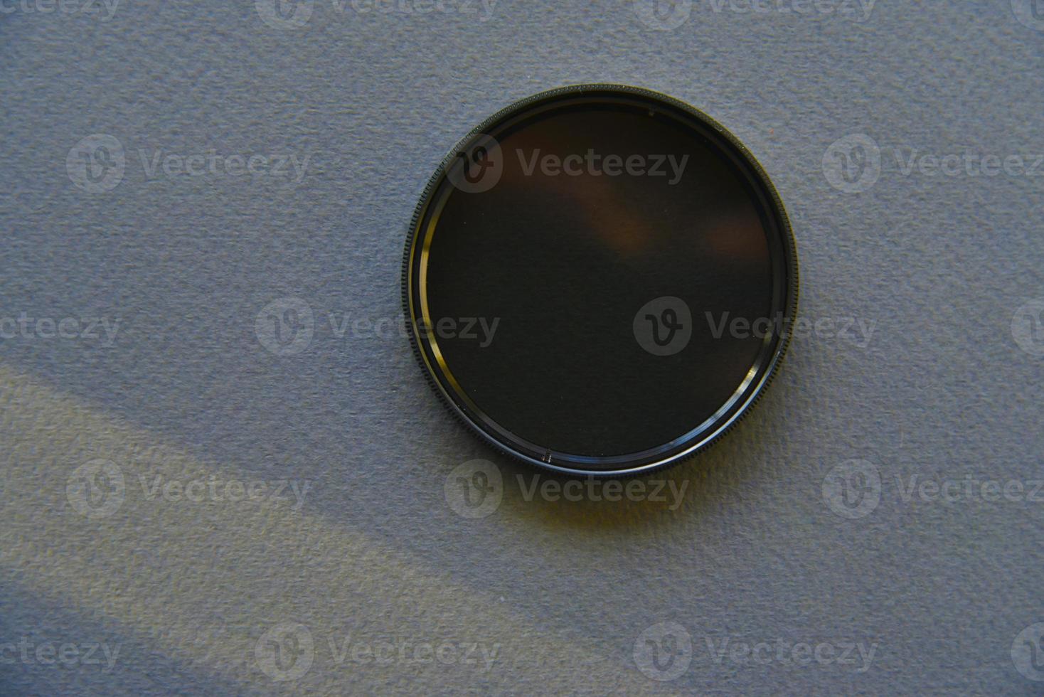 Light filter for a photo lens on a gray background