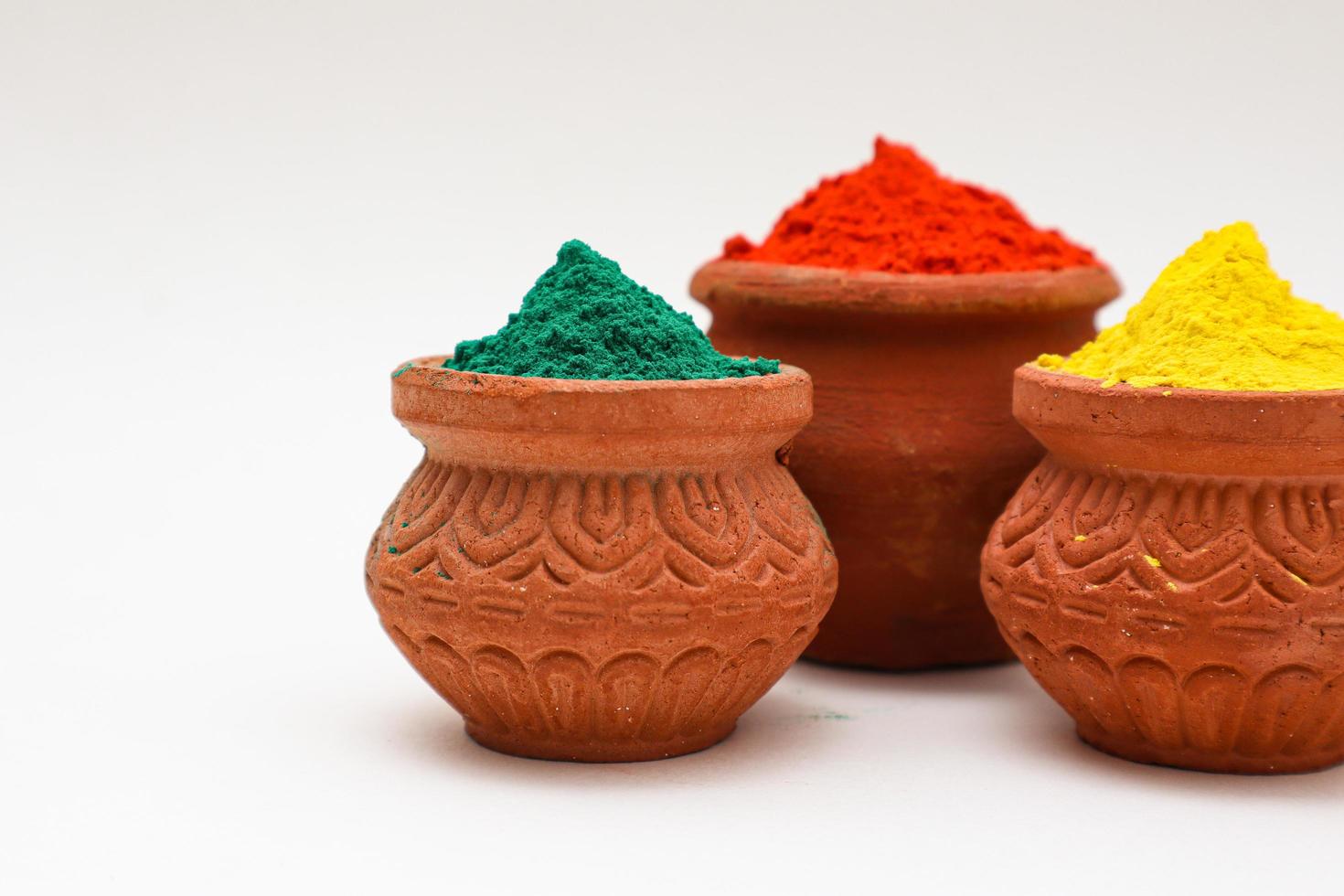 bowl with colors of holi on white background. photo