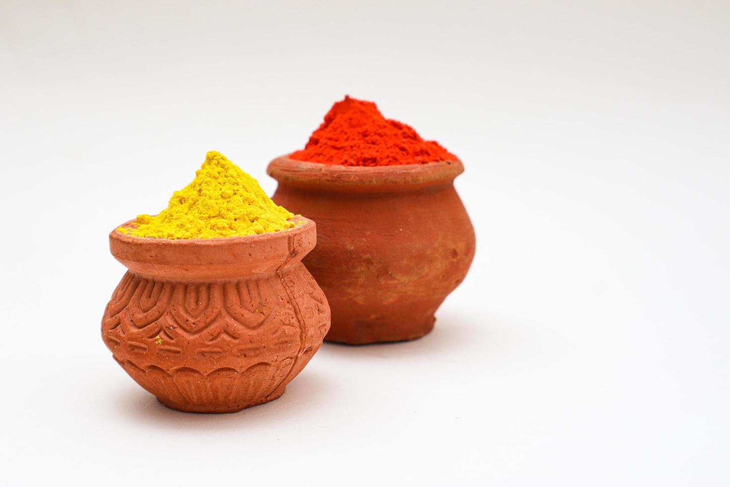 Indian festival Holi concept  bowl with colors of holi on white background. photo