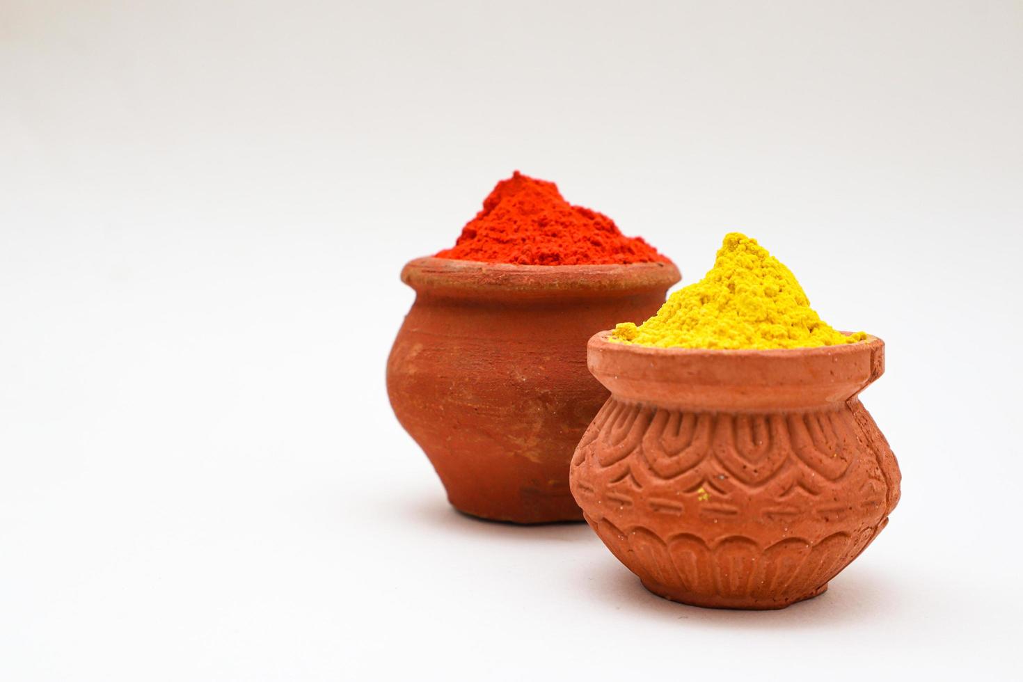 bowl with colors of holi on white background. photo