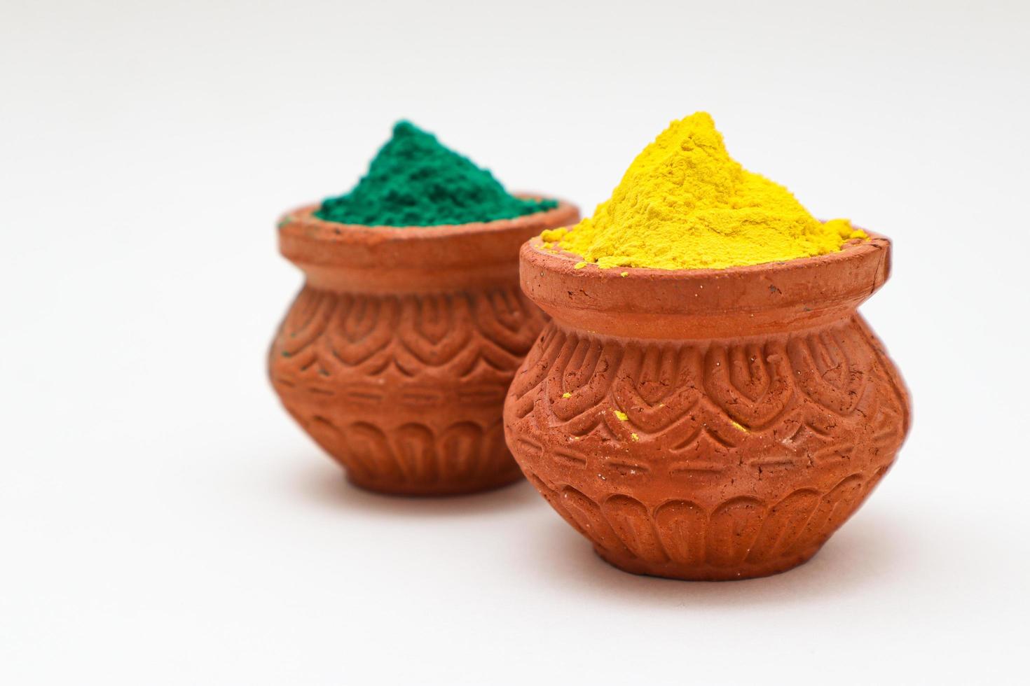 Indian festival Holi concept  bowl with colors of holi on white background. photo