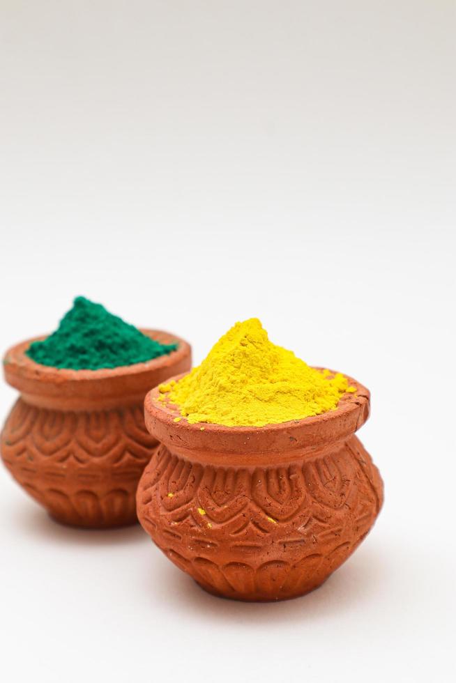 Indian festival Holi concept  bowl with colors of holi on white background. photo