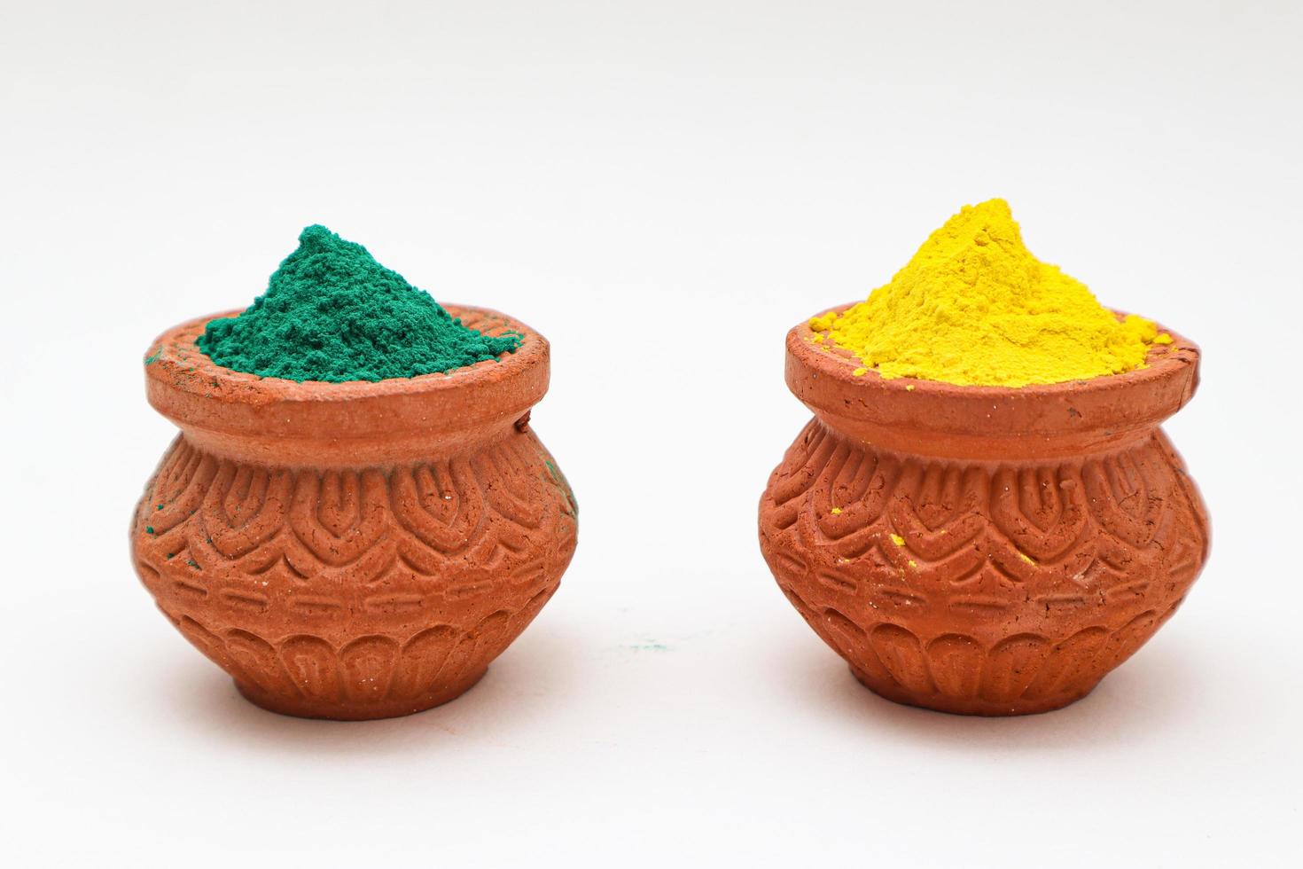 Indian festival Holi concept  bowl with colors of holi on white background. photo