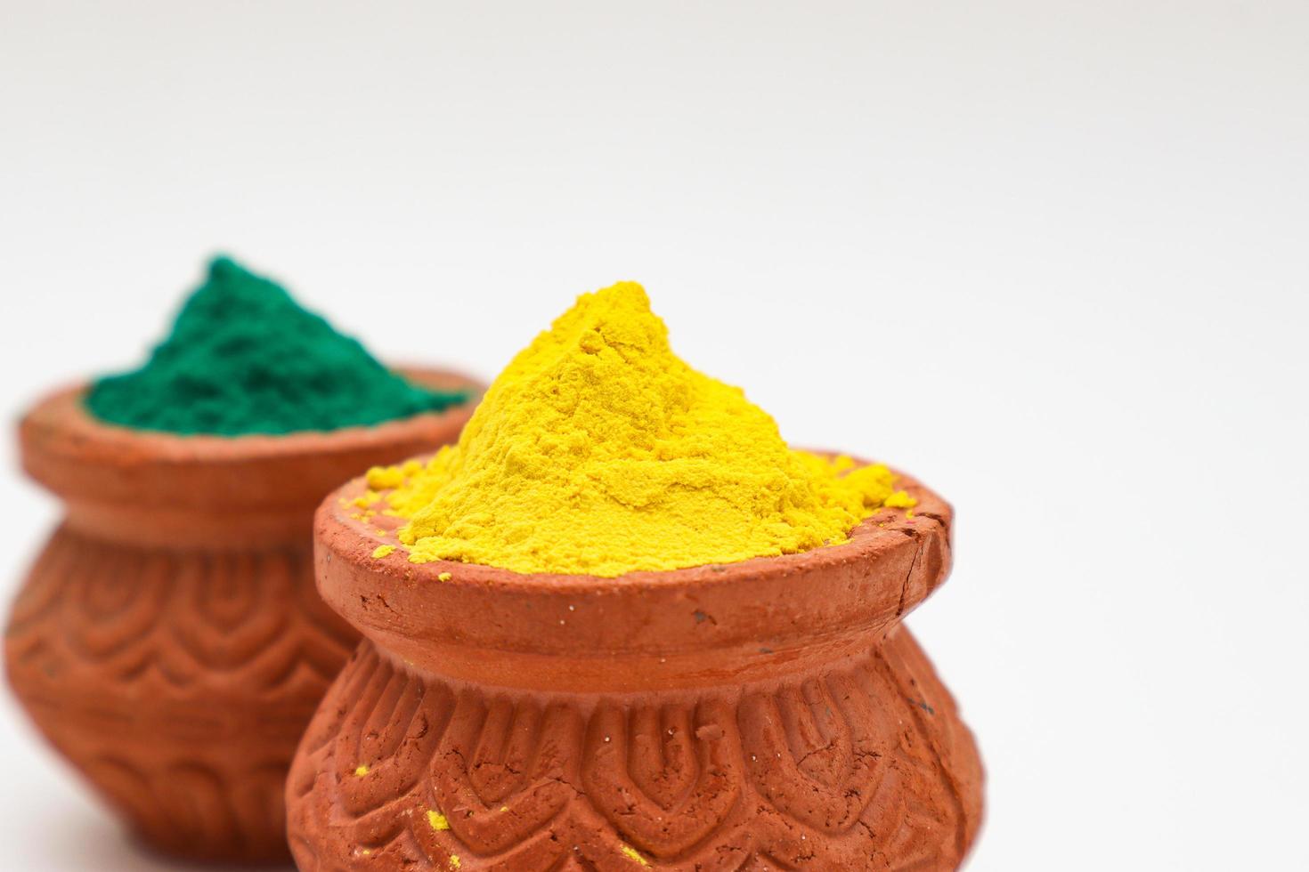 Indian festival Holi concept  bowl with colors of holi on white background. photo