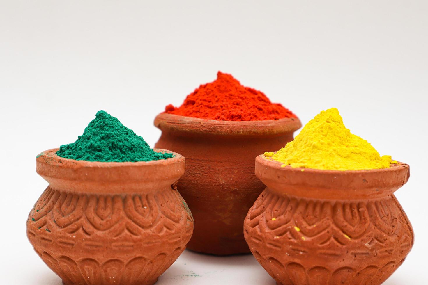 bowl with colors of holi on white background. photo