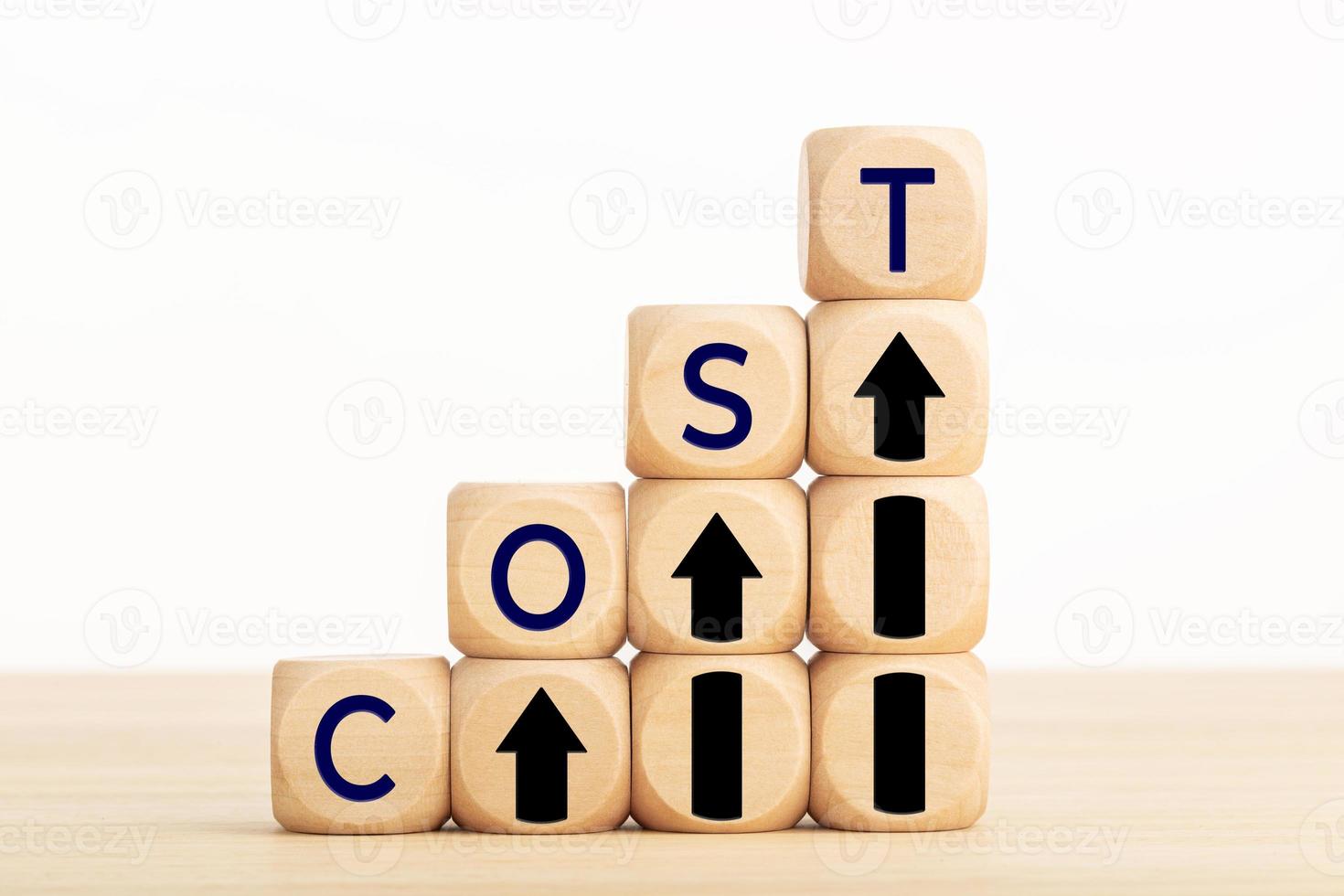 Cost growth concept. Text and Arrow icon on wooden blocks. Copy space photo