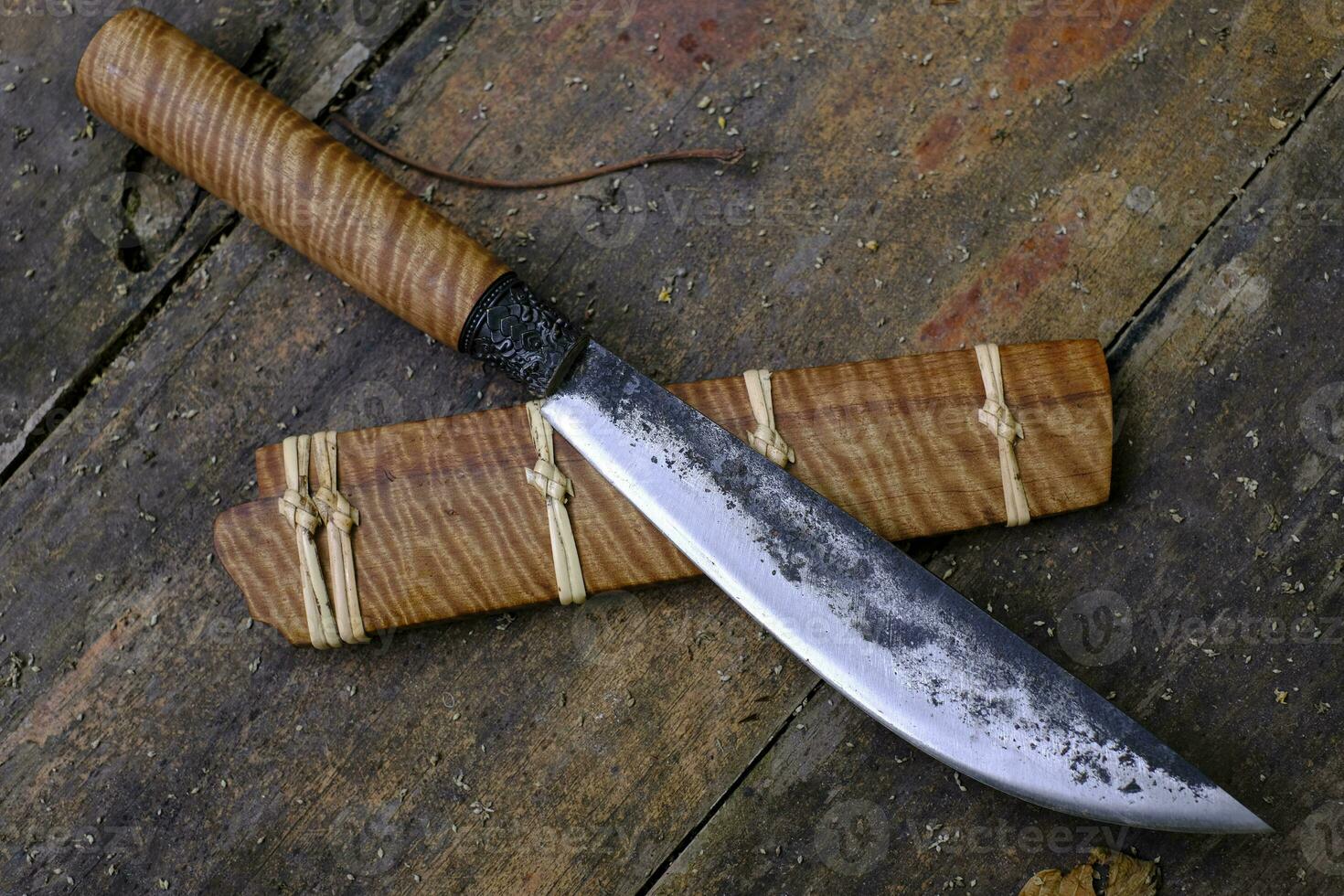 Enep knife custom in the natural Tiger patterned Tabaek wood casing on old table handmade of Thailand photo