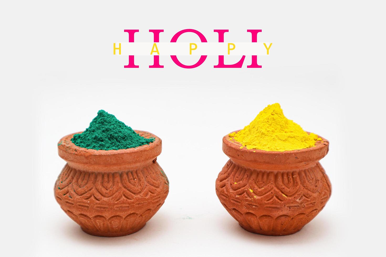 Indian festival Holi concept Multi color's bowl with colorful background and writing happy holi photo