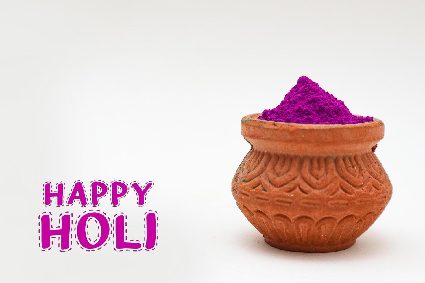 Indian festival Holi concept Multi color's bowl with colorful background and writing happy holi photo