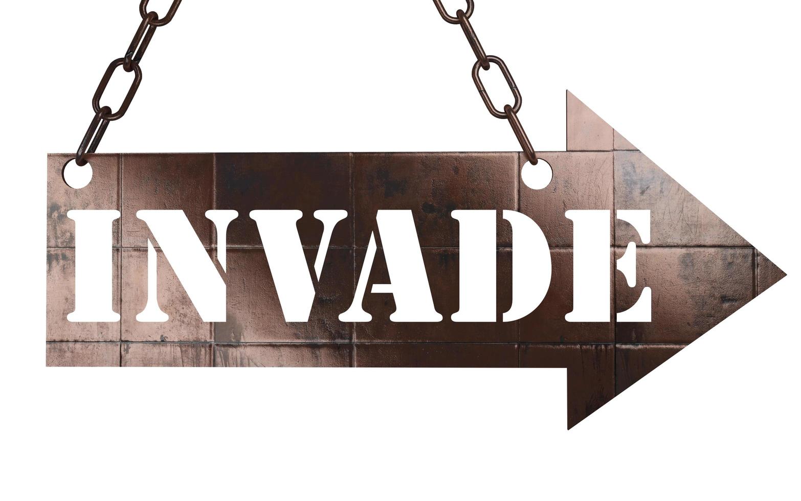 invade word on metal pointer photo