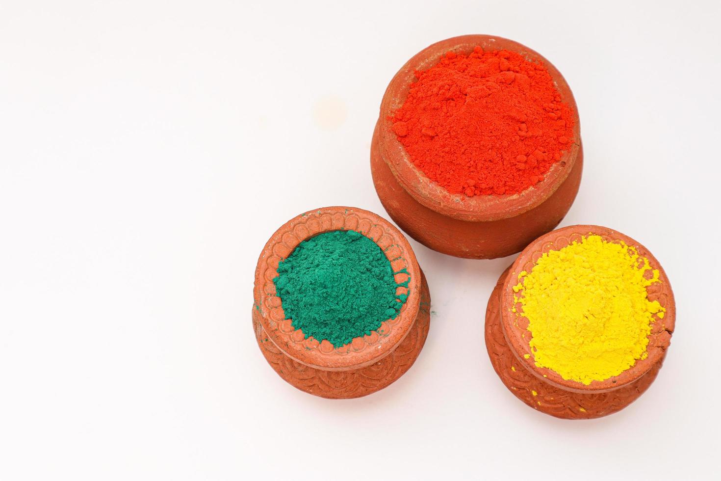 Indian festival Holi concept  bowl with colors of holi on white background. photo