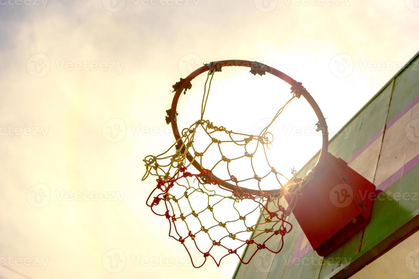 Wooden basketball hoop with sunset background photo