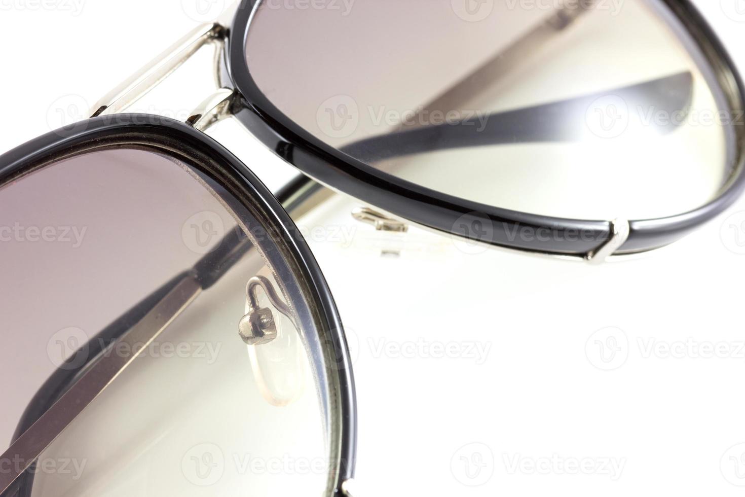 Black sunglasses close up. Isolated on white background photo