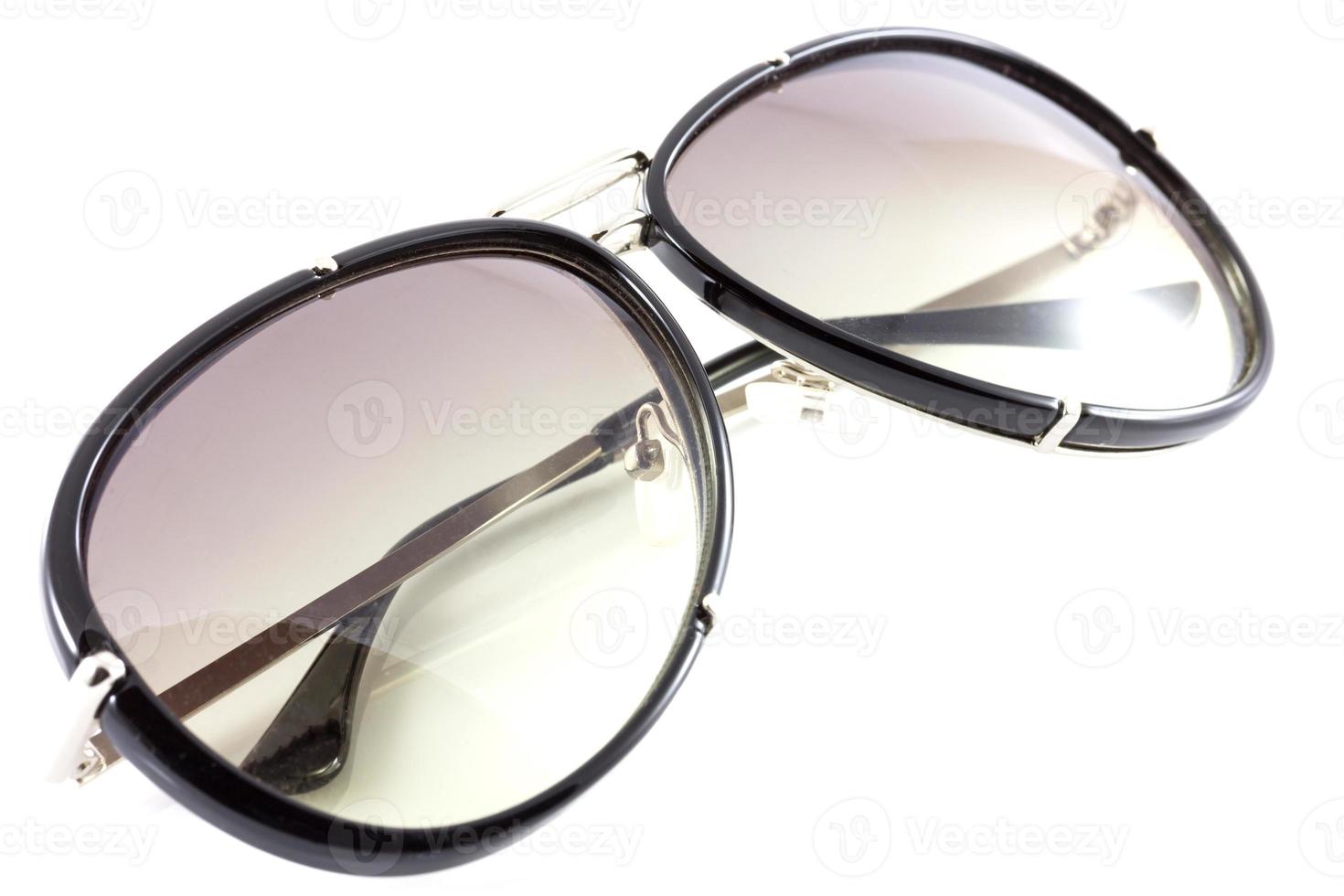 Black sunglasses close up. Isolated on white background photo