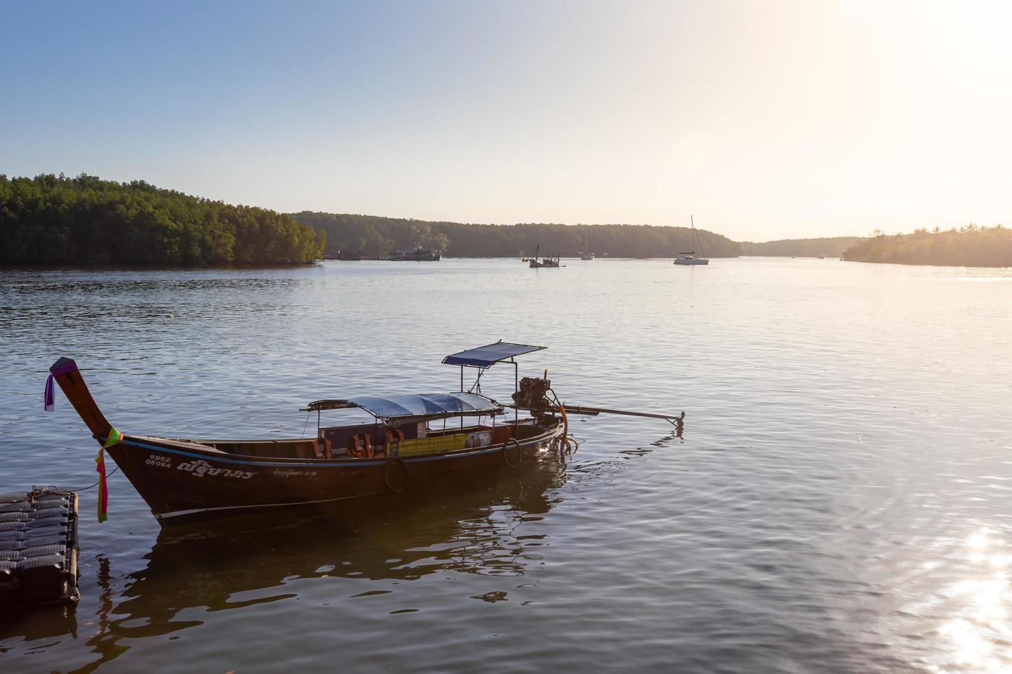 KRABI, THAILAND - JANUARY 23, 2020 - Beautiful natural view of boats, pier, mangrove forest at Krabi River, Krabi, Thailand. photo