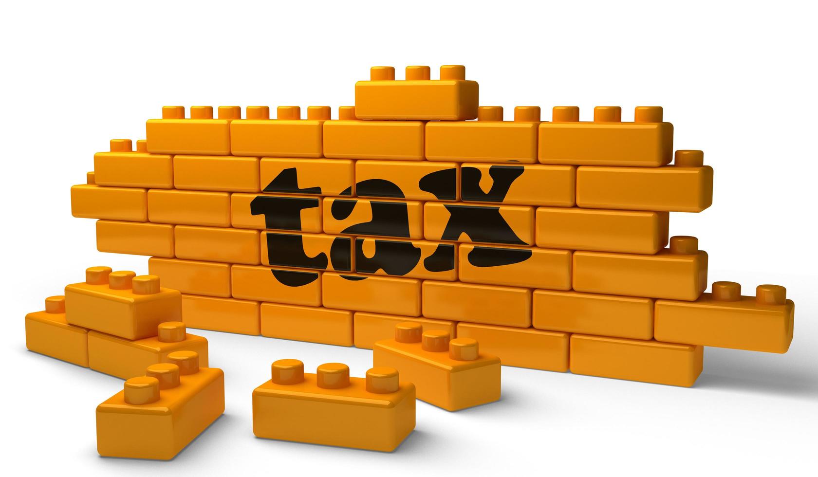 tax word on yellow brick wall photo