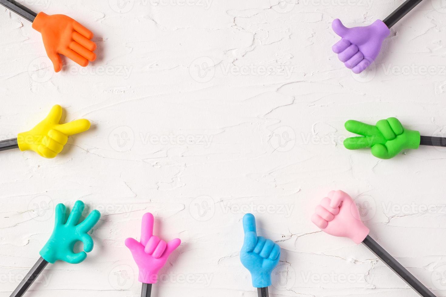 group of toy hand gesture on pencil with white paster concrete background photo