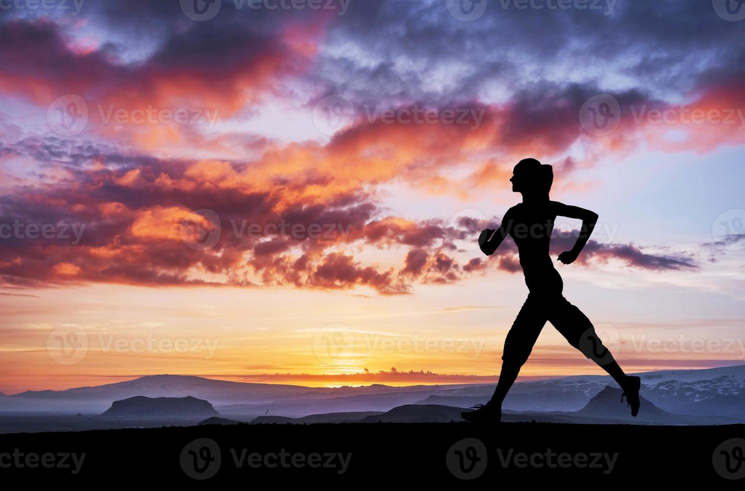 A sports girl at dawn is engaged in yoga. Fitness classes at sunset photo