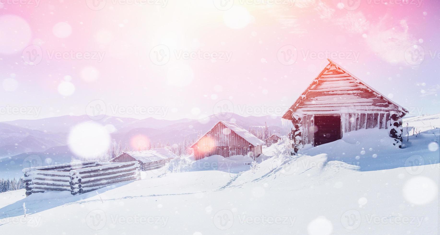 Hut in the mountains in winter, background with some soft highlights and snow flakes. Carpathians, Ukraine. photo