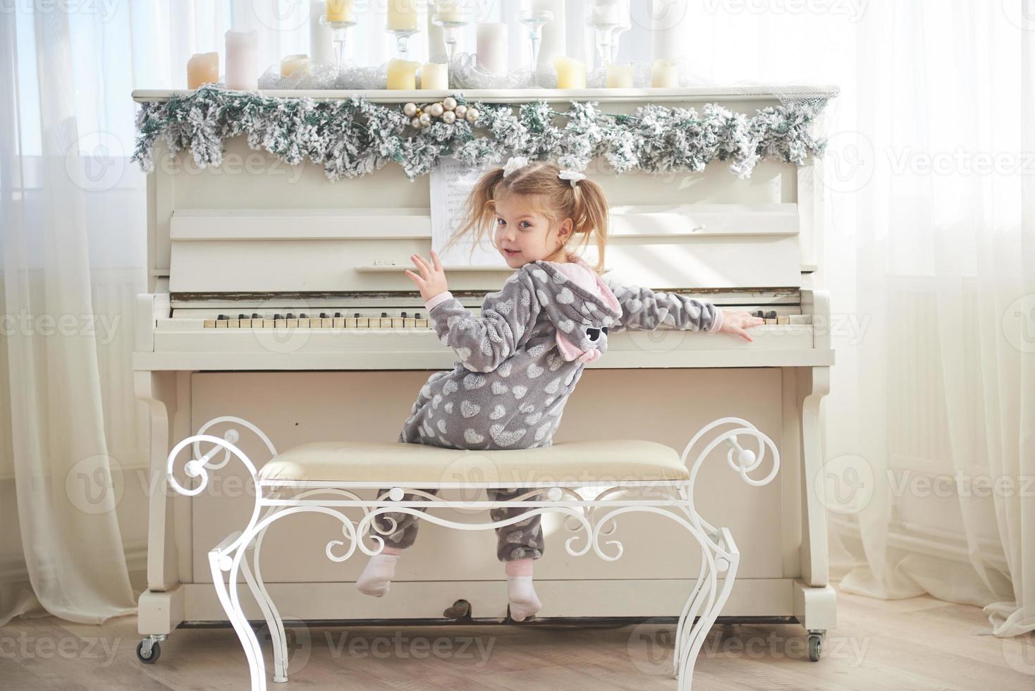 happy little girl play the piano on Christmas day photo