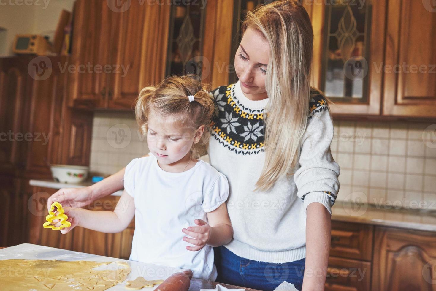 Happy girl with her mom dough photo