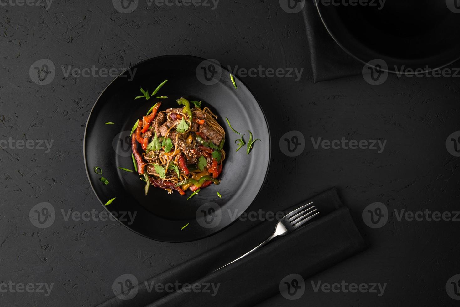a meat dish on a black surface photo