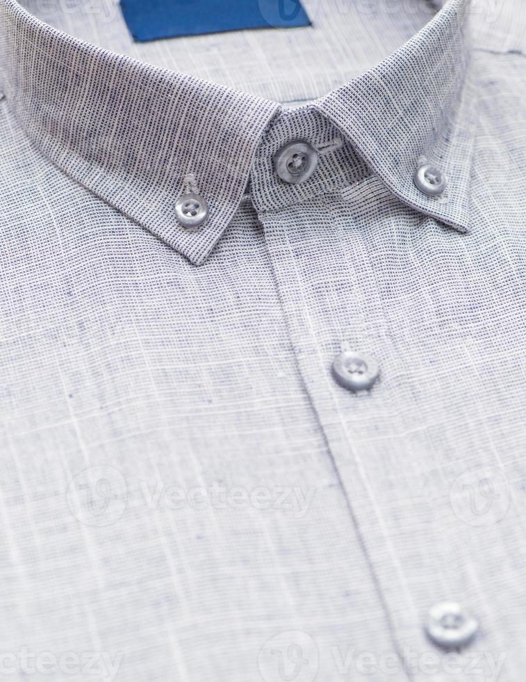 cotton shirt with a focus on the collar and button, closeup photo