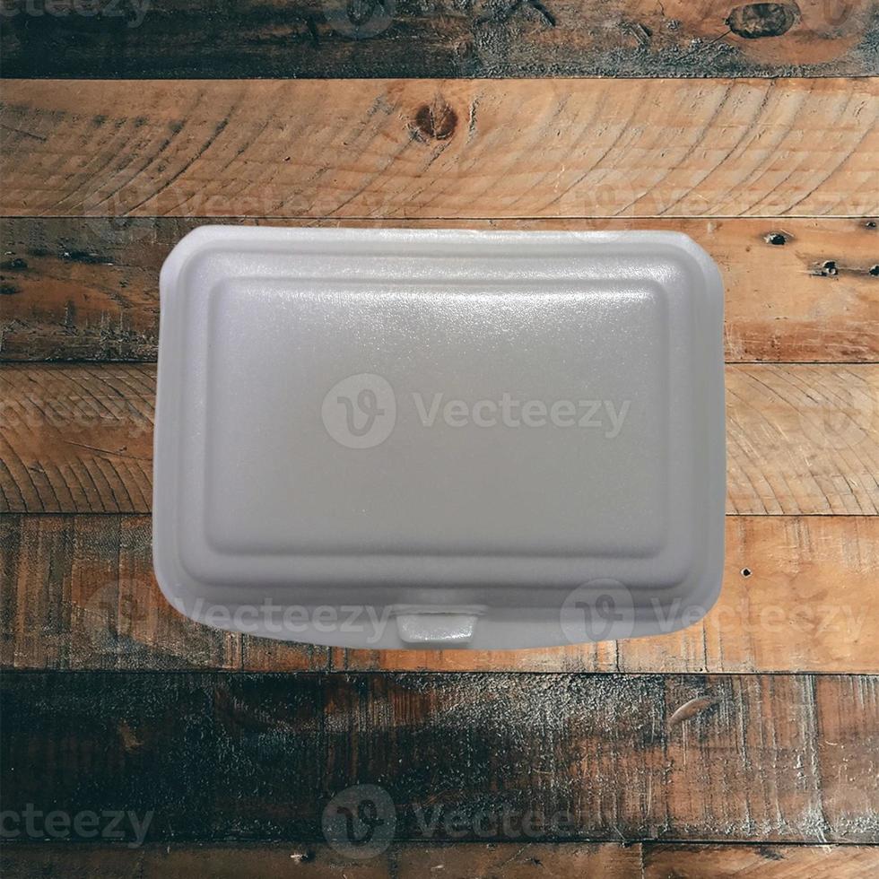 Styrofoam container with wood background photo