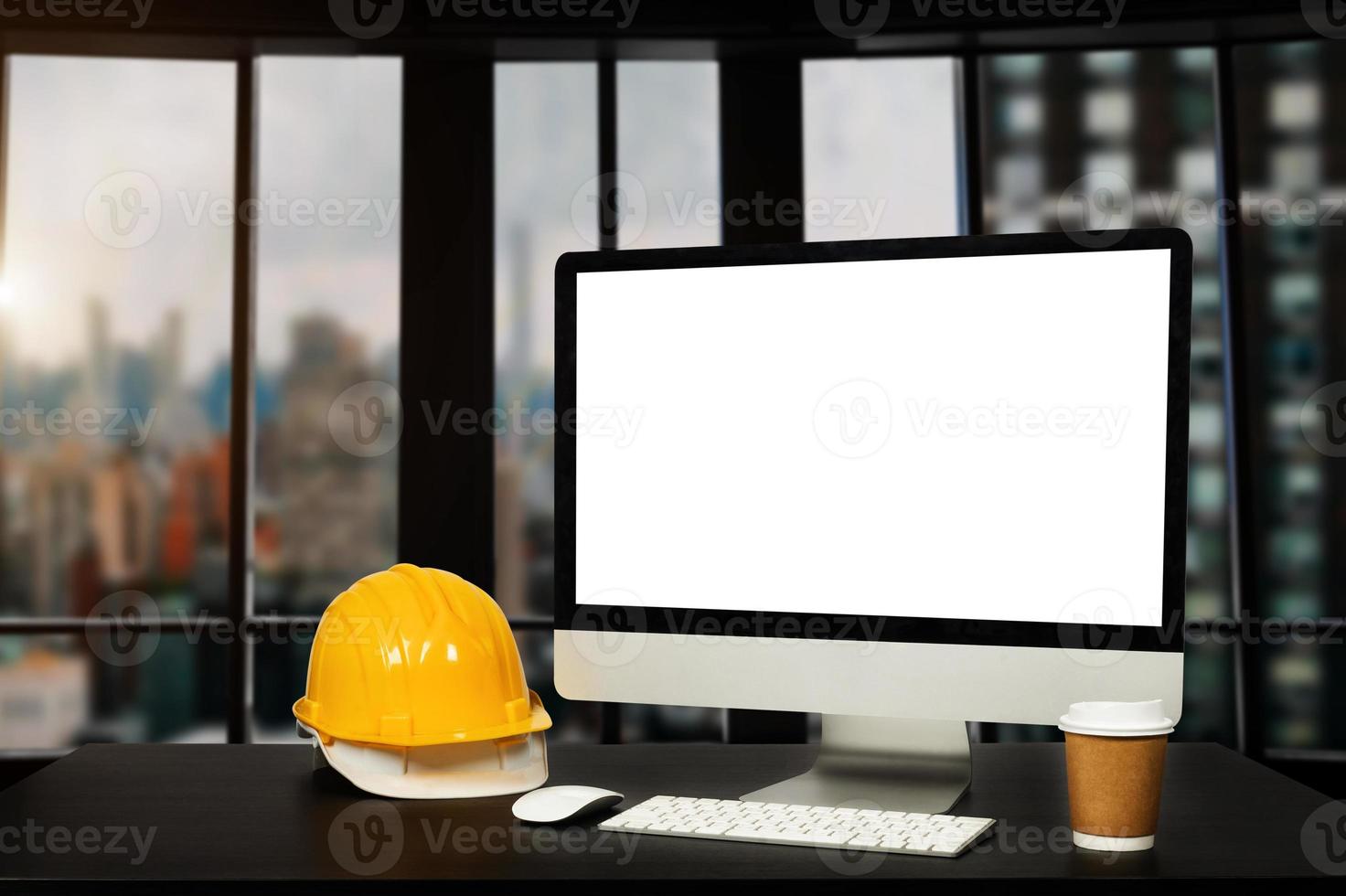 Front view of computer and office construction on table in office blurred background.Architect concept. photo