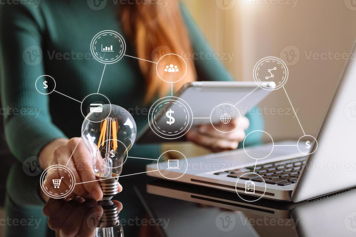 business man hand holding lightbulb with using smartphone and calculator to calculate and money stack. idea saving energy and accounting finance photo