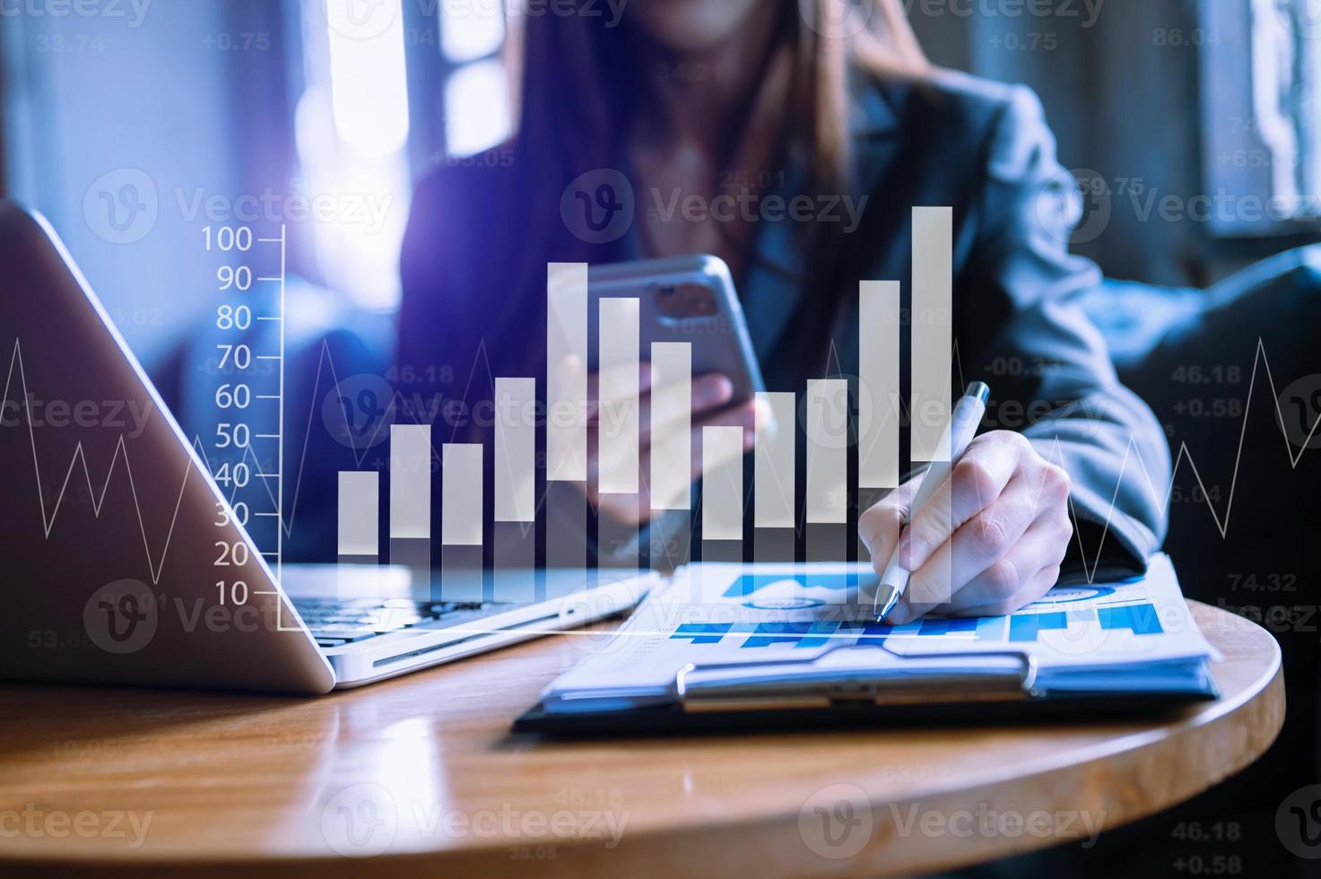 businessman working with digital tablet computer and smart phone with financial business strategy layer effect on desk photo