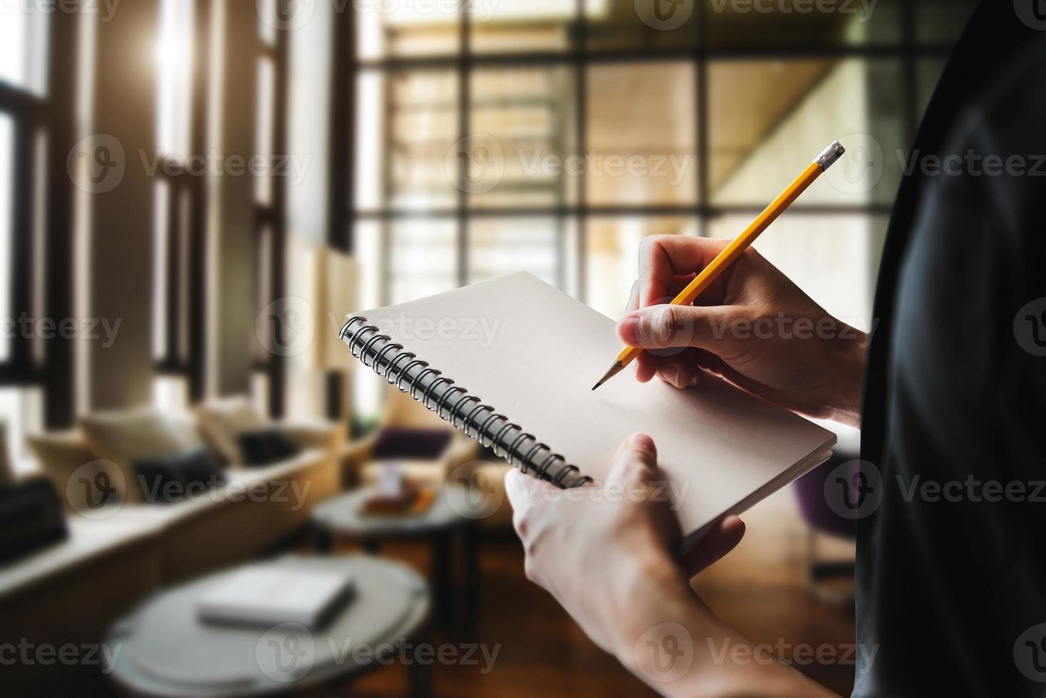 ose up of woman's hand writingis taking notes photo