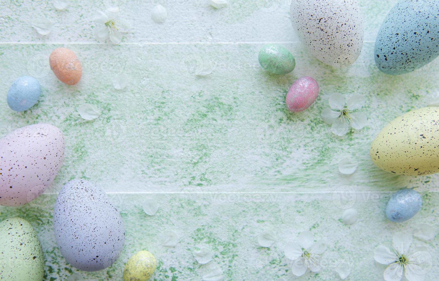 Colorful Easter eggs on green wooden background photo