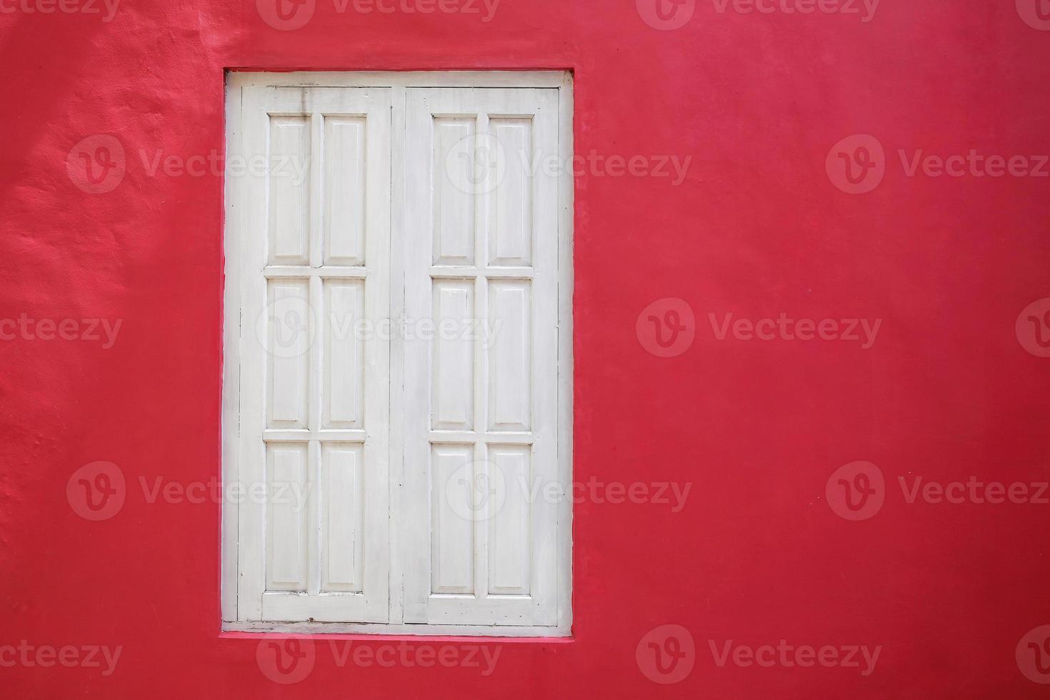 Old white wood window on red wall photo